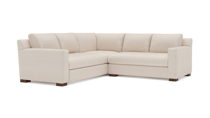 Beige L-shaped sectional sofa with plush cushions and wooden legs, modern living room style.