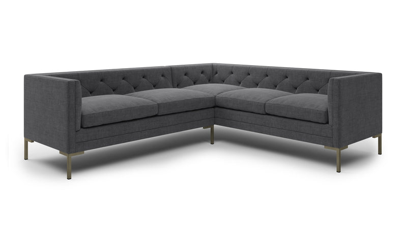 A gray sectional sofa with tufted back and arms, and gold legs, on a white background.